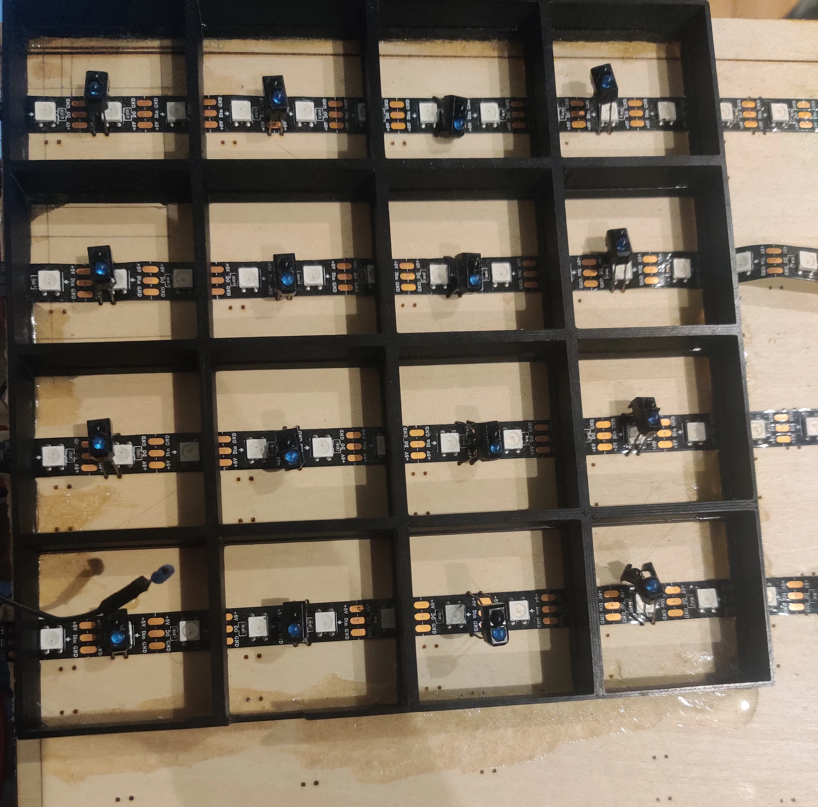 Initial 4x4 infrared prototype showing 3D printed black grid, LED strips, and infrared sensors in each square