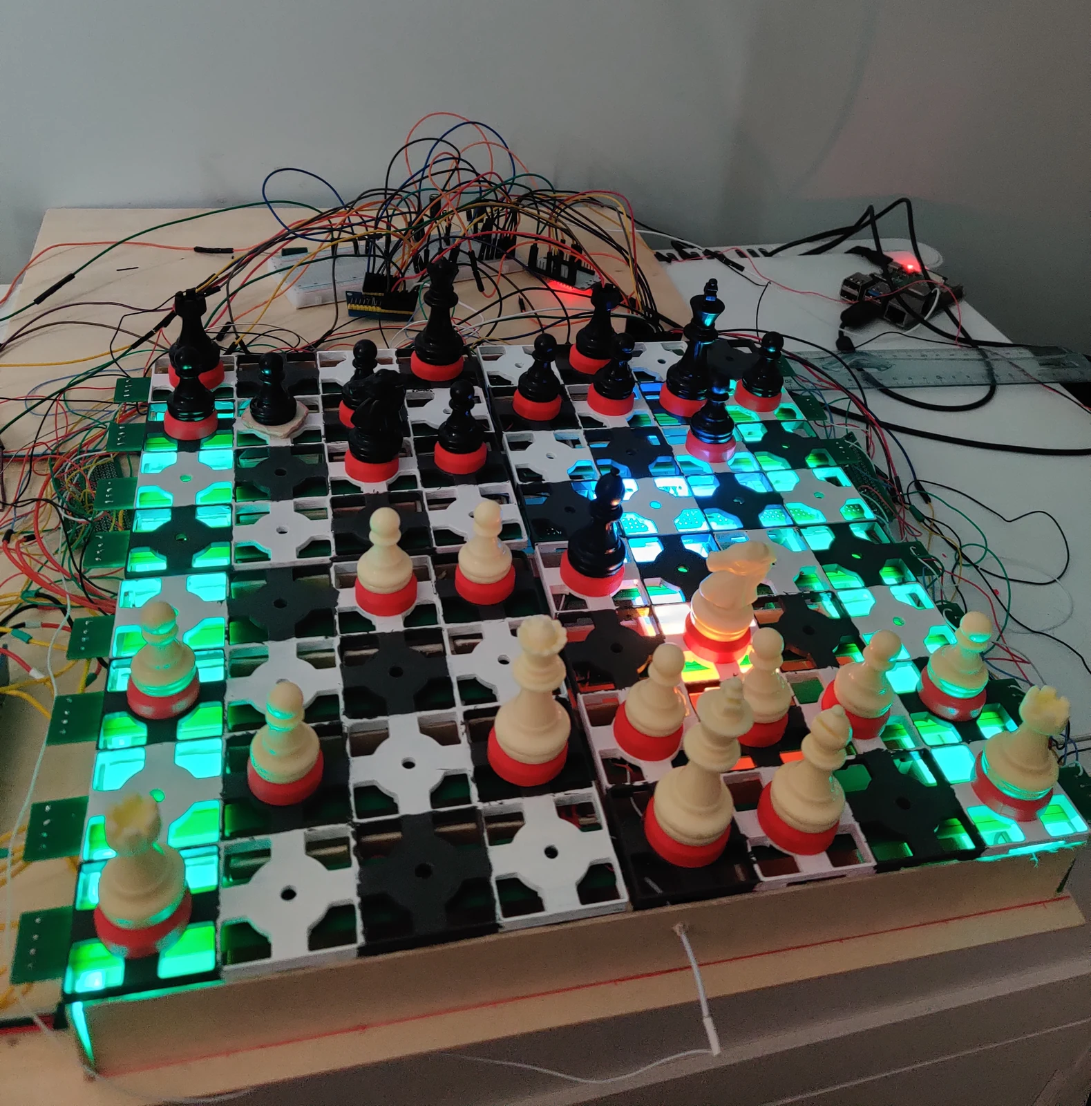Full 8x8 Smart Chess Board V2 lit up with green, cyan, and red LEDs under the 3D-printed grid
